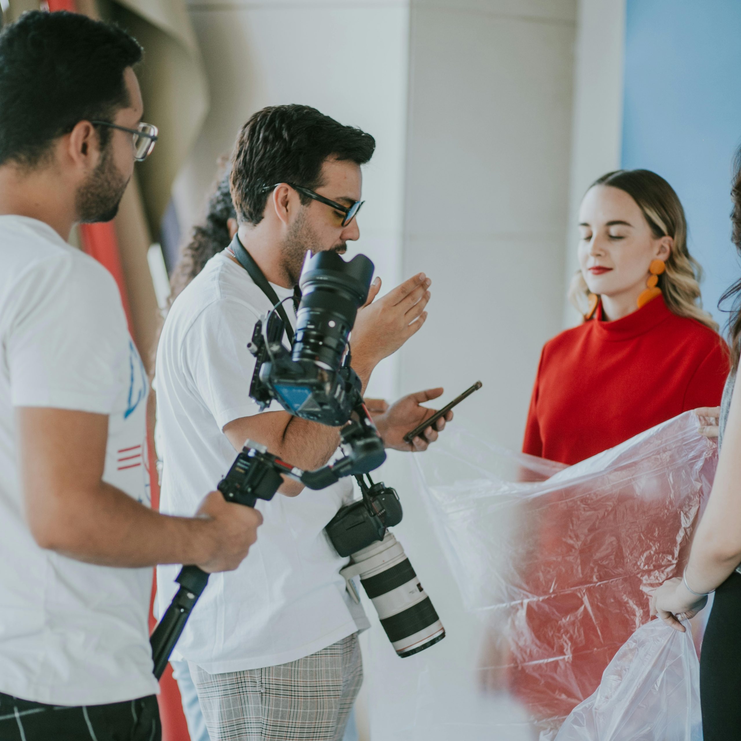 Behind-the-scenes look at a professional photoshoot setup with models and photographers.